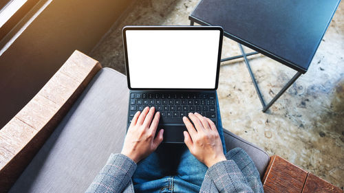 Low section of woman using laptop