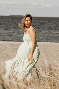 Young woman standing at beach