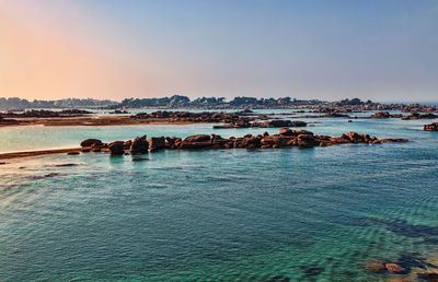 Scenic view of sea against clear sky during sunset