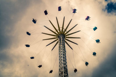 Low angle view of amusement park ride against sky