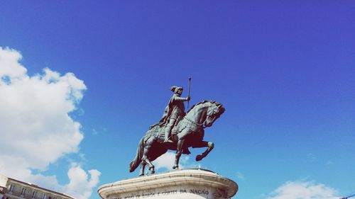 Low angle view of statue against blue sky