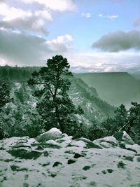 Scenic view of mountains against cloudy sky