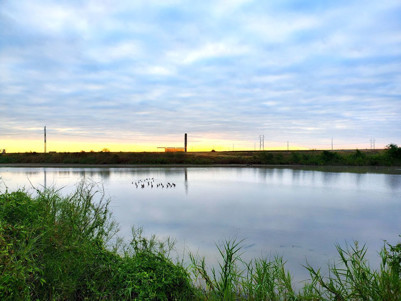 SCENIC VIEW OF LAKE AT SUNSET