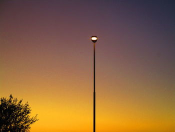 Low angle view of street light against sky at sunset