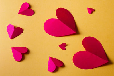Close-up of heart shapes on yellow background
