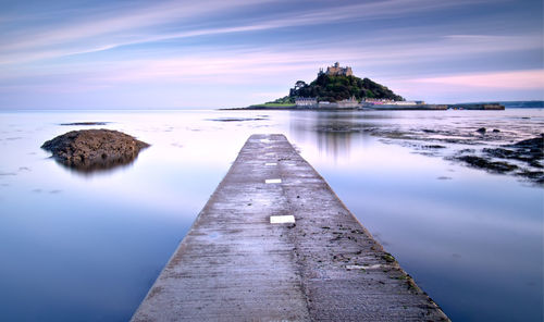 Scenic view ofst michael's mount against sky at sunset