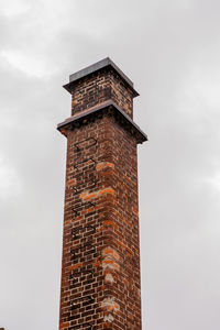Low angle view of clock tower against sky