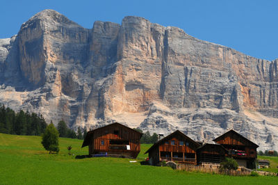 Scenic view of house and mountains against sky