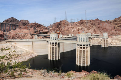 View of the penstock towers over lake mead at hoover dam, between arizona and nevada states, usa.