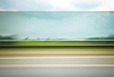 Blurred motion of road seen through train window