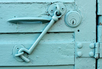 Close-up of latch hanging on door