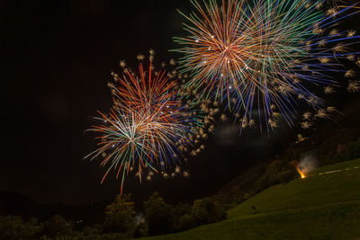 Low angle view of firework display at night