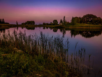 Scenic view of lake against sky at sunset