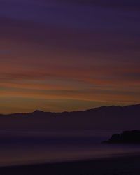 Scenic view of sea against romantic sky at sunset