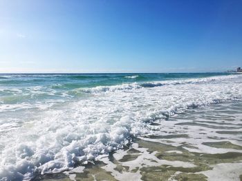 Scenic view of sea against blue sky