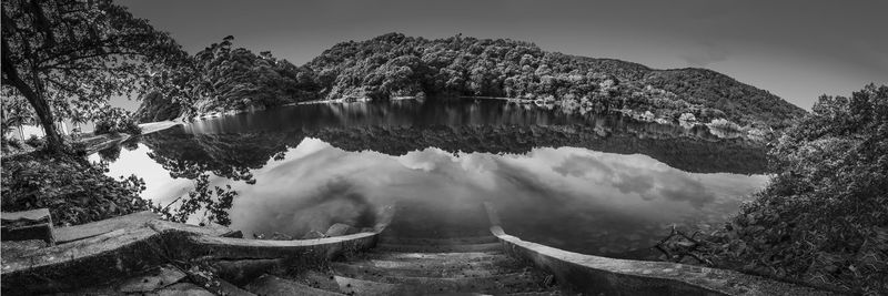 Panoramic view of lake and trees against sky