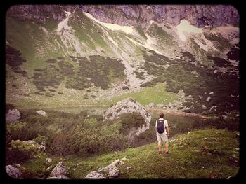 Man hiking on grassy landscape