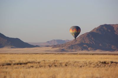 Hot air balloon flying over land