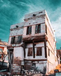 Low angle view of abandoned building against sky