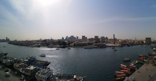 High angle view of buildings by river against sky