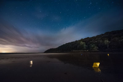 Scenic view of sea against sky at night