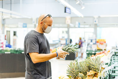 Man buying fresh fruit in supermarket