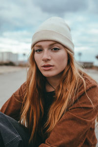 Portrait of young woman wearing hat