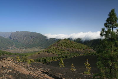 Countryside landscape against mountain range