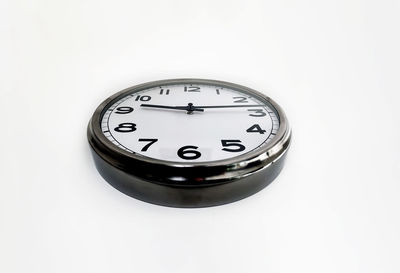 Close-up of clock over white background