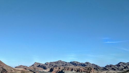 Low angle view of mountains against clear blue sky