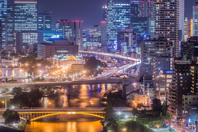 Illuminated city street and buildings at night