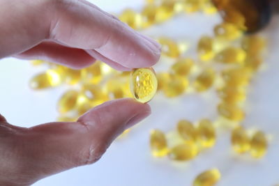 Close-up of hand holding yellow lemon