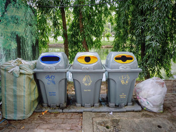 Group of plastic trash bins with different types of waste separation