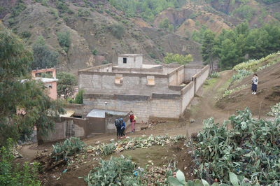 High angle view of people walking on street amidst buildings