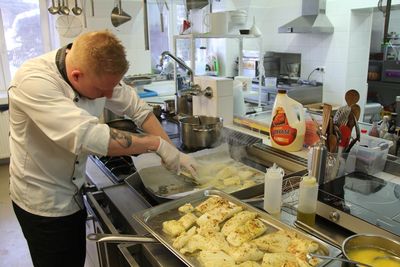 Midsection of man preparing food in kitchen