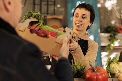 Portrait of young woman holding food at home