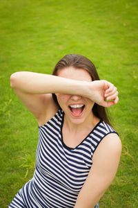 Portrait of a smiling young woman on field