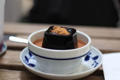 Close-up of black jelly with thai tea on table