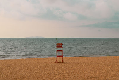 Lifeguard hut on beach against sky