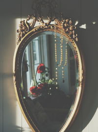 Rosary hanging by mirror at home