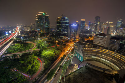 High angle view of city lit up at night