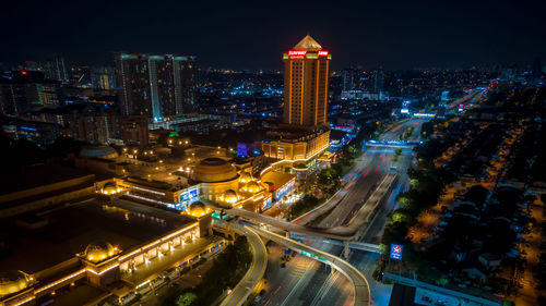 High angle view of city lit up at night