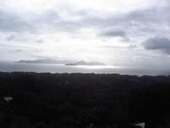 Scenic view of mountains against cloudy sky