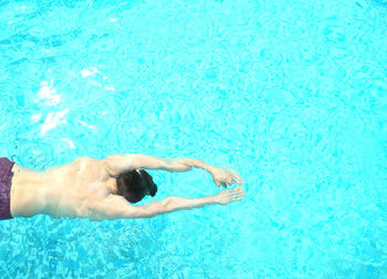 Young man swimming in pool