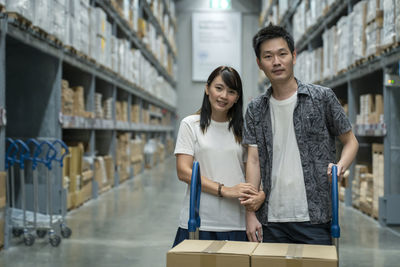 Portrait of young couple asian shopping new lifestyle of stock product inventory on shelf 