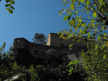 Low angle view of old building against clear blue sky