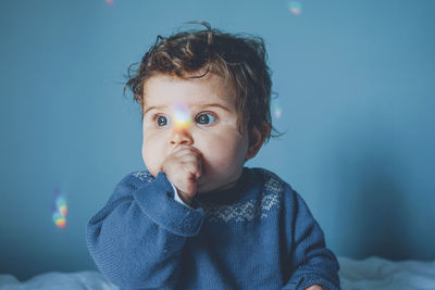 Cute baby girl on bed at home