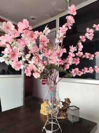 Pink flower vase on table at home