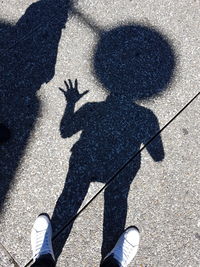 Low section of man standing on street
