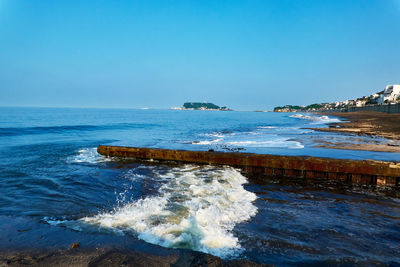 Scenic view of sea against clear blue sky